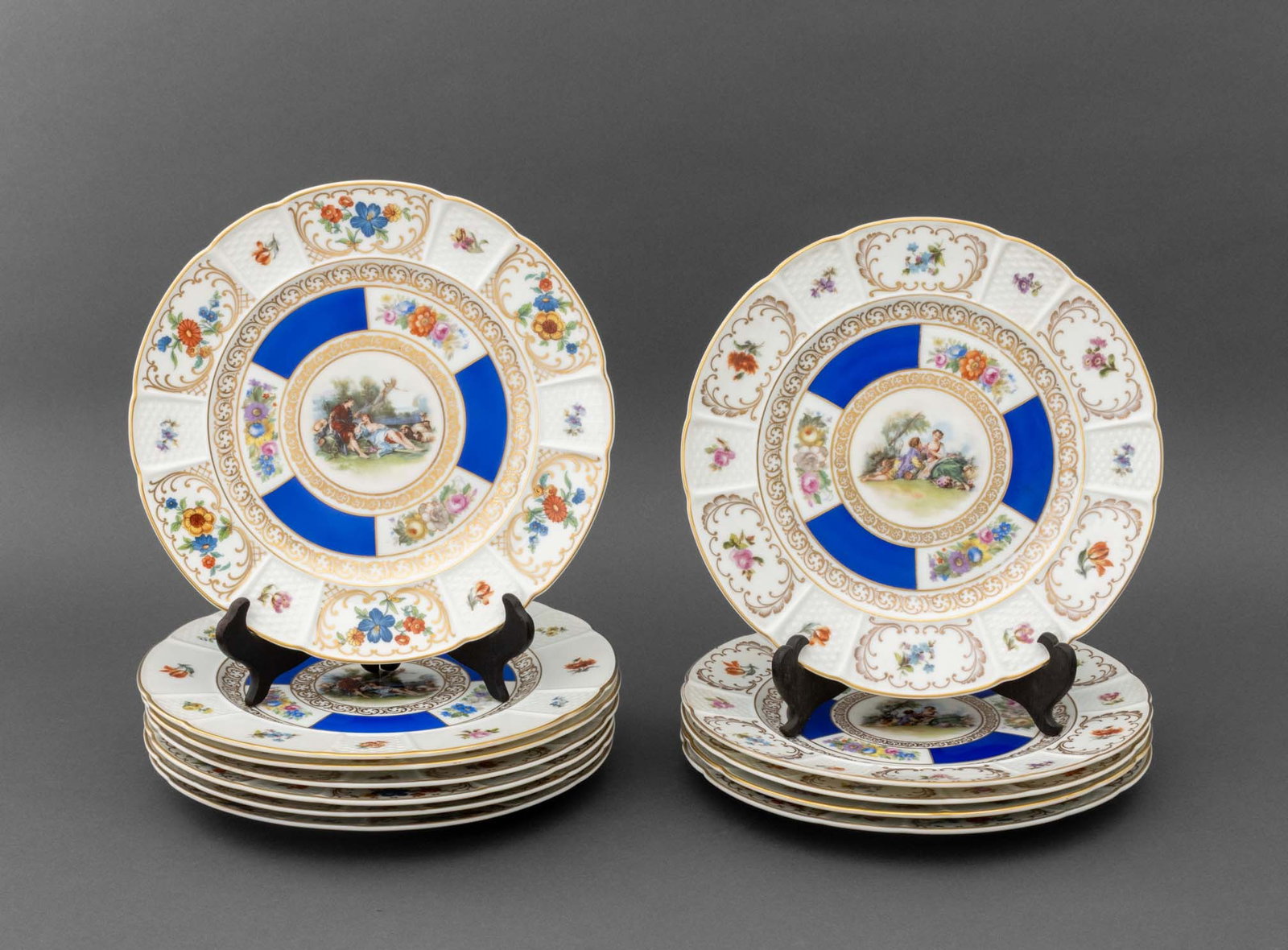 Rosenthal Porcelain Dinner Plates, 12: Set of 12 Rosenthal for The Hardy and Mayes Company Porcelain Dinner Plates, each with courting scene to center and hand-painted floral and scrollwork design, marked to undersides. 10.5" Diameter. Pro