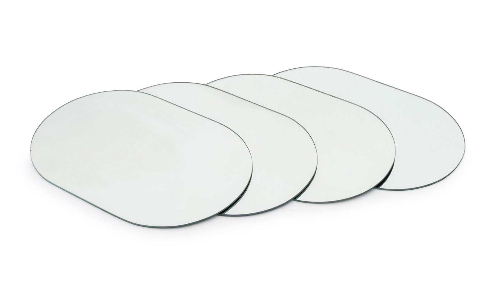 Modern Mirrored Glass Oval Placemats, 4: Set of Four Modern Mirrored Glass Oval Place Mats. 18" L x 12" W. Provenance: From a New York City Collection. Keywords: Tableware, Dining, Dinnerware, Minimalism, Minimalist, Looking glass, Place