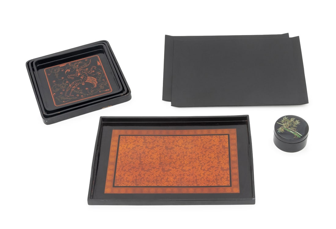Asian Black Lacquered Tableware Articles, 13: Collection of Thirteen Asian Black Lacquered Tableware Articles, comprising: pair of serving trays, set of six coasters in a covered jar marked "Made in Japan" to underside, a double-handled tray, and