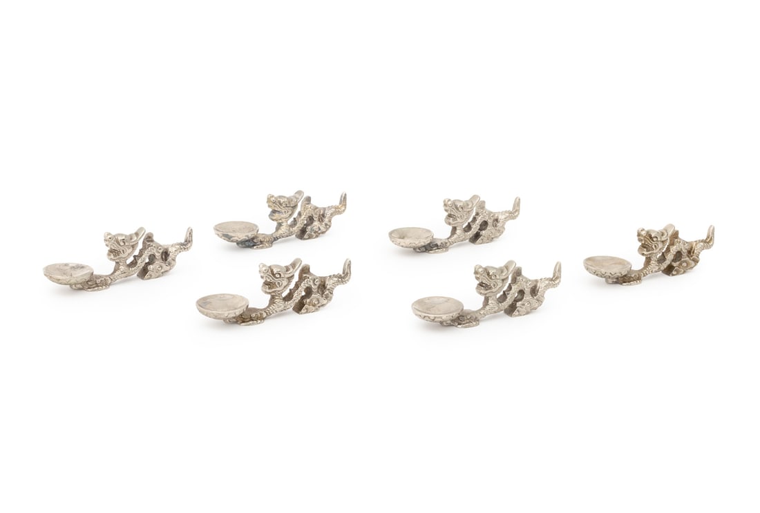 Chinese Dragon Form Incense Holders, 6: Group of Six Chinese Silver-Tone Metal Dragon Form Incense Burners, each dragon upholding a small dish. 1.5" H x 4.25" W x 1.25" D. Provenance: From a New York City Collection. Keywords: Asian Arts, C