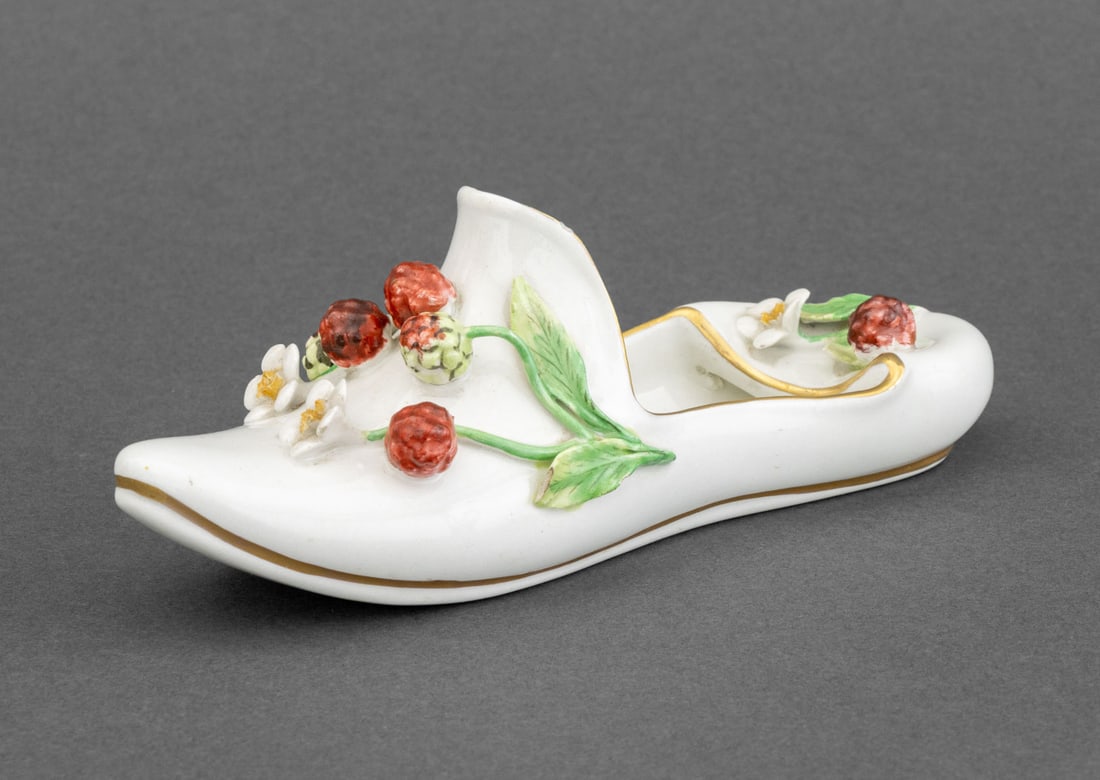 Mottahedeh Porcelain Shoe Form Catchall Dish: Mottahedeh Porcelain Shoe Form Catch-all Dish, decorated with berry and blossom appliques, gilt decorated, marked "Italy" and with Mohattahedeh label to underside. 2.25" H x 6" W x 2" D. Provenance: F