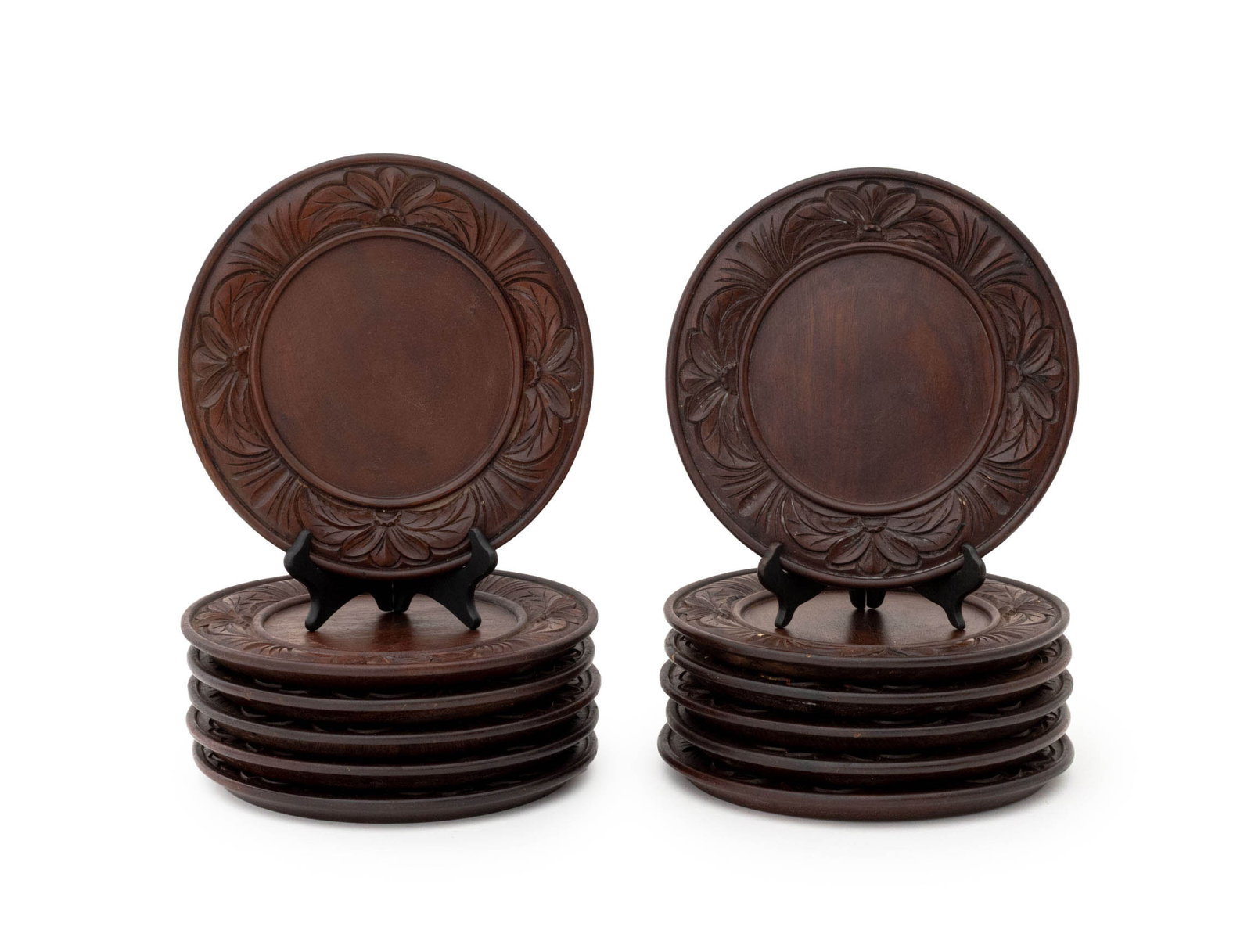 Black Forest Carved Wood Dinner Plates, 12: Set of 12 Black Forest Carved Wood Dinner Plates, with floral carved border. 12" Diameter x 1" H. Provenance: From an Upper West Side Estate. Keywords: Woodwork, Treen, Treenware, Vintage, Rustic, Car