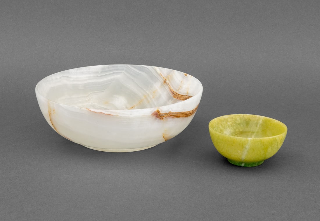 Carved Stone Bowls, 2: Group of Two Carved Stone Bowls, the larger a white onyx centerpiece bowl, the smaller a greenstone tea bowl. Larger: 3.25" H x 9.75" Diameter. Provenance: From a 45 Sutton Place South Estate. Keyword