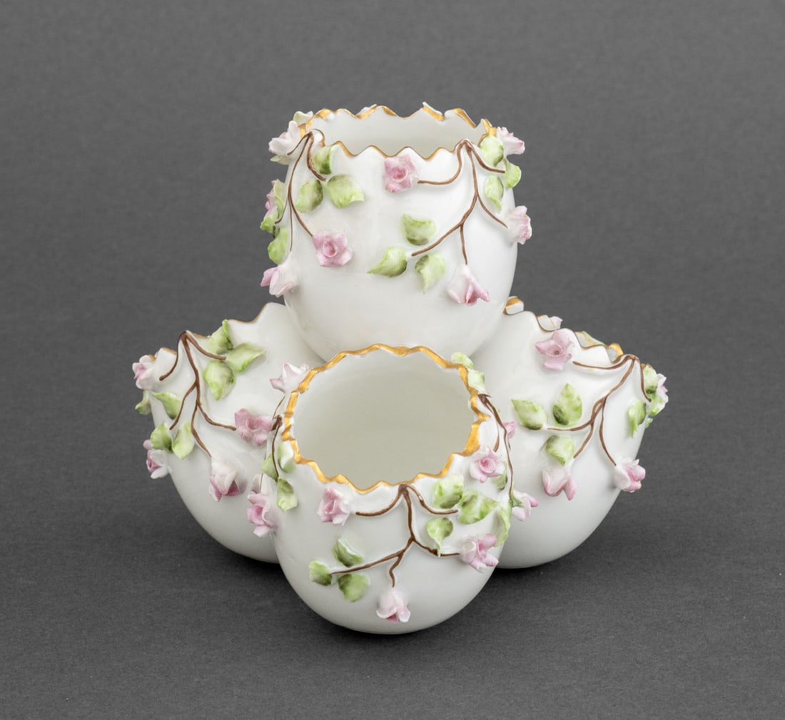 Vista Alegre Porcelain Egg Cluster Vase: Vista Alegre Porcelain Egg Cluster Vase, the four vases with applied pink flowers and green leaves, marked "VA / Portugal / Made in Portugal" to underside. 3.75" H x 4.25" W x 4.25" D. Provenance: Fro