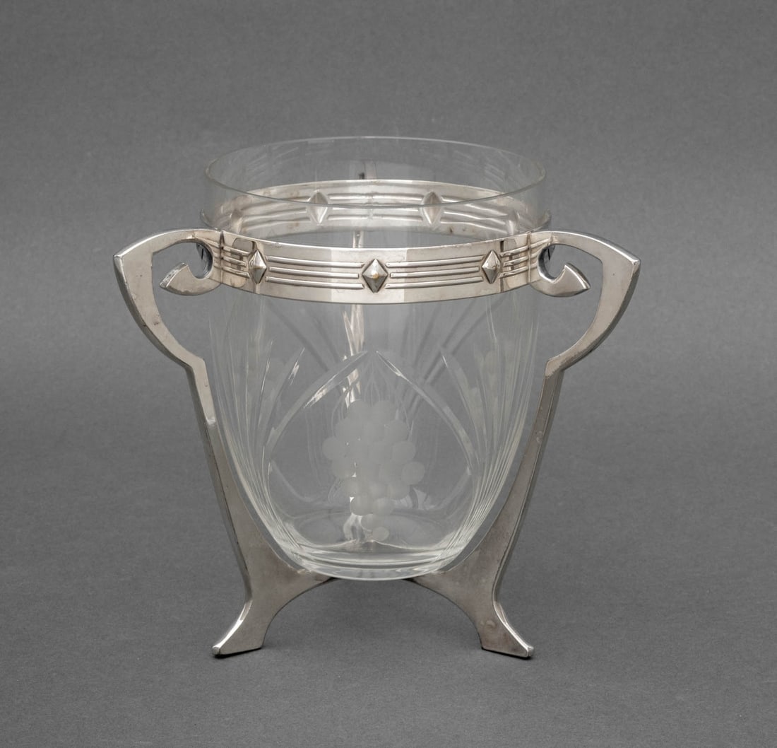 Jugendstil Style Chrome and Glass Centerpiece Vase: Jugendstil Style Chrome and Glass Centerpiece Vase, glass insert with cut glass ferns and etched grape clusters, tripod frame with partial marks underside. 6.25" H x 6.5" W x 6.5" D. Provenance: From 