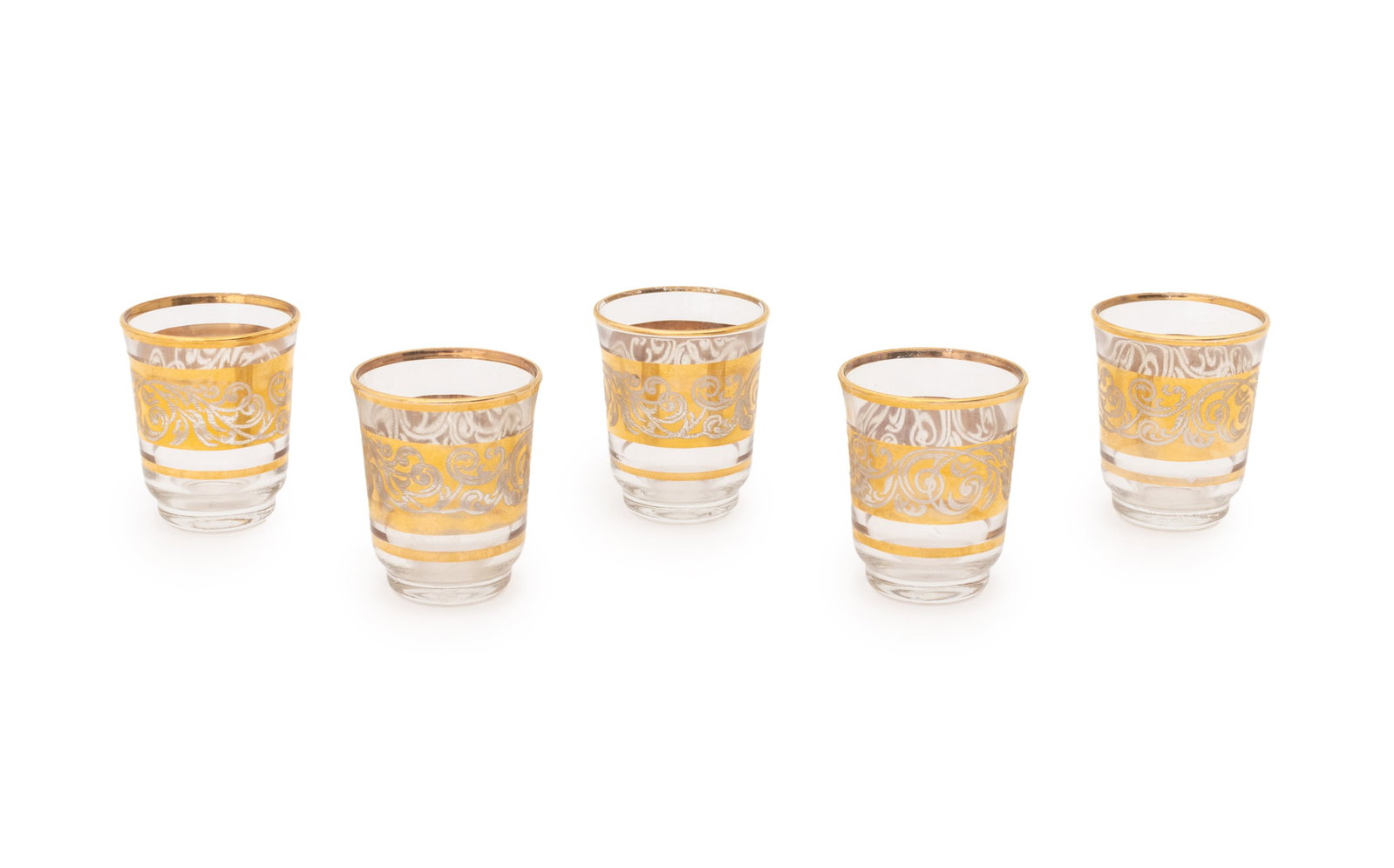 French Gilt Decorated Glass Liqueur Glasses, 5: Set of Five French Gilded Glass Liquor Glasses, each marked "France" to underside. 2" H x 1.5" Diameter. Provenance: The Morningside Heights Estate of an Academic. Keywords: French glass, Tableware, D