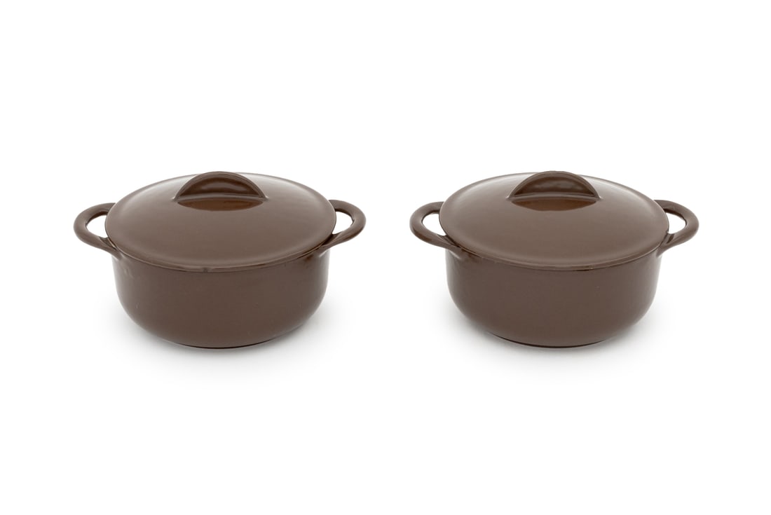 Le Creuset Enameled Cast Iron Covered Dishes, 2: Le Creuset Enameled Cast Iron Covered Dishes, chocolate brown enamel, two handled dishes, one marked "Le Creuset" the other marked "Cousances" to lid. 3.5" H x 6.25" W x 5" D. Provenance: From a Tribe