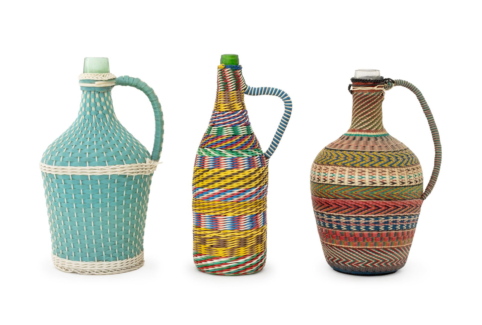 Collection of Balkan Scoubidou Bottles, 3: Collection of Three Balkan Mid-Century Modern Scoubidou Bottles, woven plastic wrapped glass. Tallest: 13.75" H x 6" W x 4.5" D. Provenance: From the Collection of Anna Condo. Keywords: Folk Art, Bohe