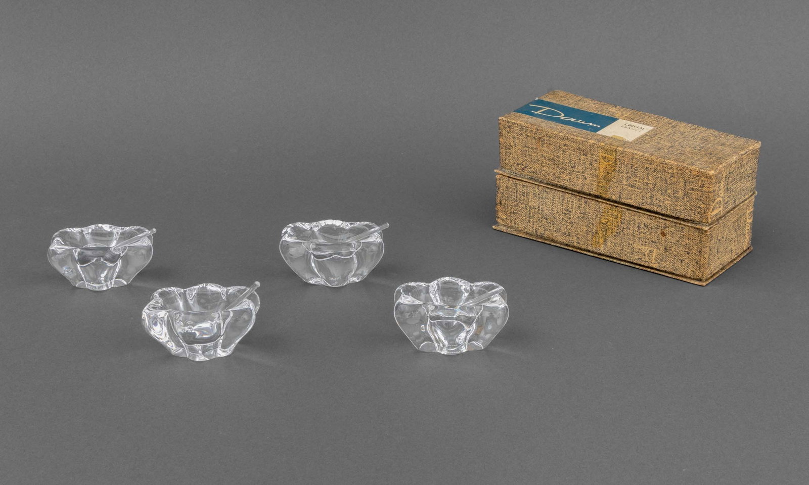 Daum Crystal Flower Form Open Salt Cellars, 4: Set of Four Daum Crystal Flower Form Open Salt Cellars, marked "Daumn / France", in original boxes. 1.25" H x 2.5" W x 2" D; box: 1.5" H x 6.25" W x 2.75" D. Provenance: From an East 79th Street Estat