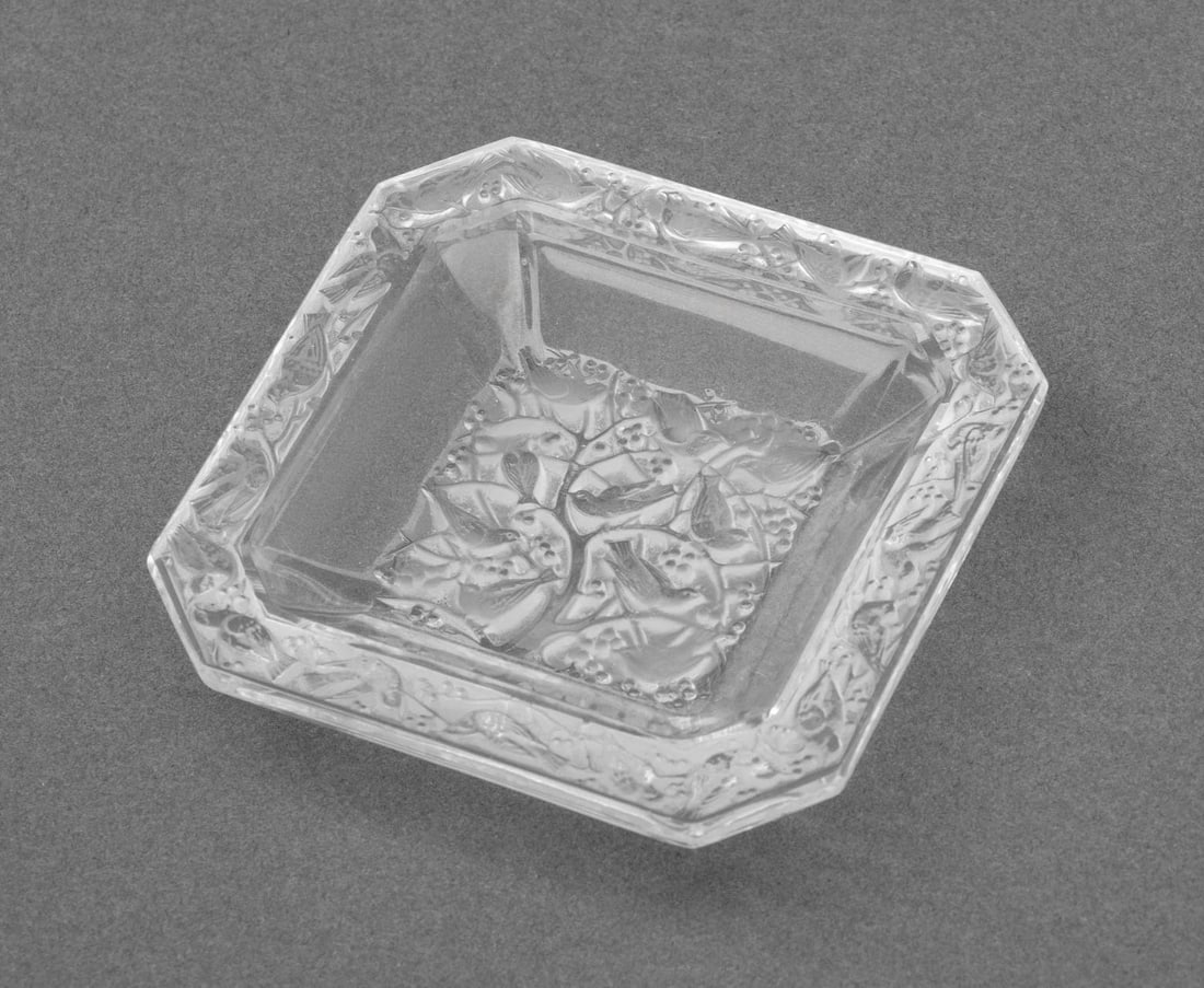 Lalique "Anna" Frosted Crystal Cendrier: Lalique "Anna" Frosted Crystal Cendrier, birds settled on the branches of a tree, smoky glass border, marked "Lalique / France" underside. 3.5" H x 3.5" W x 0.5" D. Provenance: From a New York City