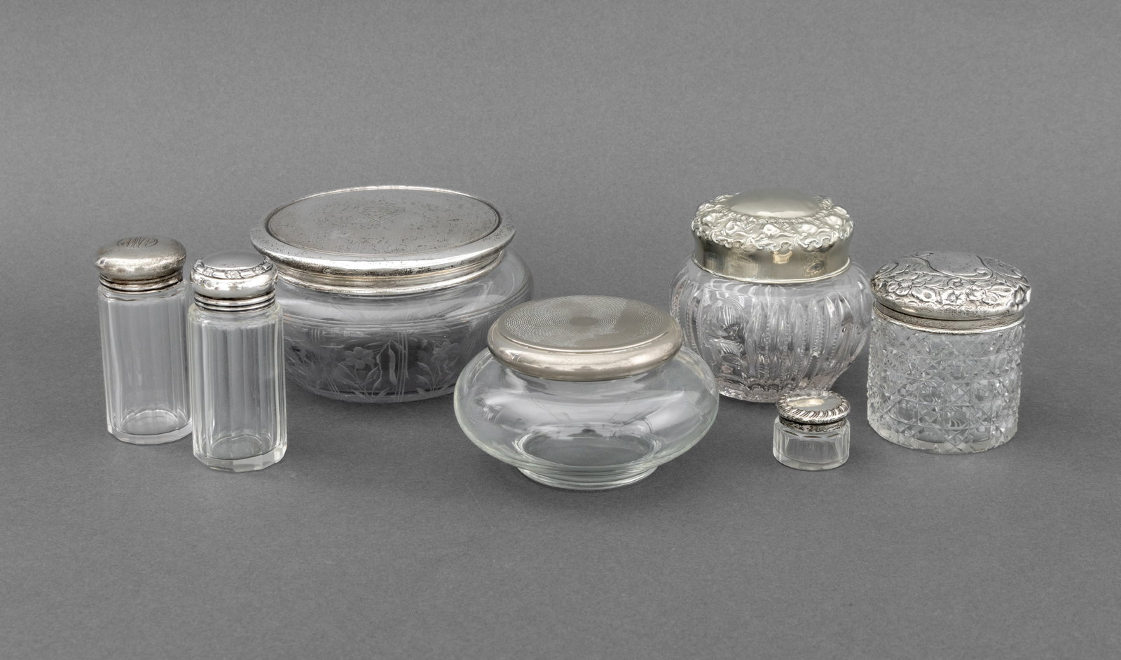 Art Nouveau Dressing Table Accessories, 7: Group of Seven Art Nouveau English and American Dressing Table Accessories, comprising: cut crystal jar with sterling silver lid, struck with marks for T. H. Hazelwood & Co., Birmingham, 1902, (2) two