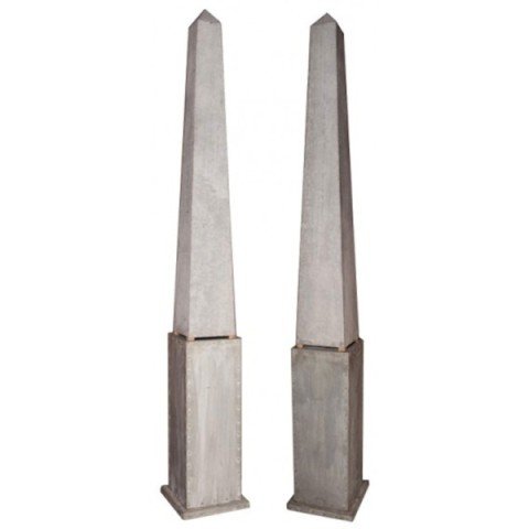 Pair of Monumental Zinc Obelisks on Pedestal Bases: Pair of custom designed monumental whitewashed zinc wrapped riveted obelisks on pedestal bases. c. Early 1980s, United States. Dimensions: Each 120" H x 14" diameter