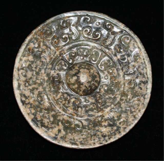 Chinese Han Dynasty Carved Jade Mirror: A carved jade mirror, China, Han Dynasty 206 BC – 220 AD; unmarked. Dimensions: 4" diameter