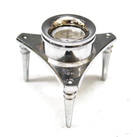 Metal Desk Loupe 10x: A metal desk loupe/ magnifying glass, 10x magnification; marked. Dimensions: 2" H x 2-1/2" diameter
