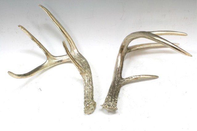 Pair of Silver Colored Antlers: A pair of silver colored plaster or porcelain antlers; unmarked. Dimensions: each 11" L