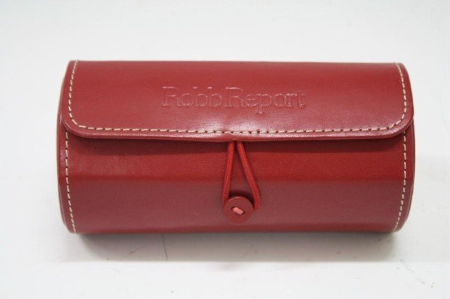 Vintage Leeman Leather Red Jewelry Roll Box: A Leeman Leather roll box/ case that opens up to three circular containers for jewelry, one with tuft holder for rings, possibly an advertising item for American luxury-lifestyle magazine "Robb Report