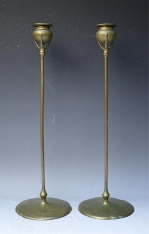 Pair of Tiffany Studios Gilt Bronze Candlesticks: Pair of art nouveau gilt bronze candlesticks, small cups sit in a three pronged setting atop a long thin column with a wide round base, Tiffany Studios #1312, New York; marked. Dimensions: each 18-5/8