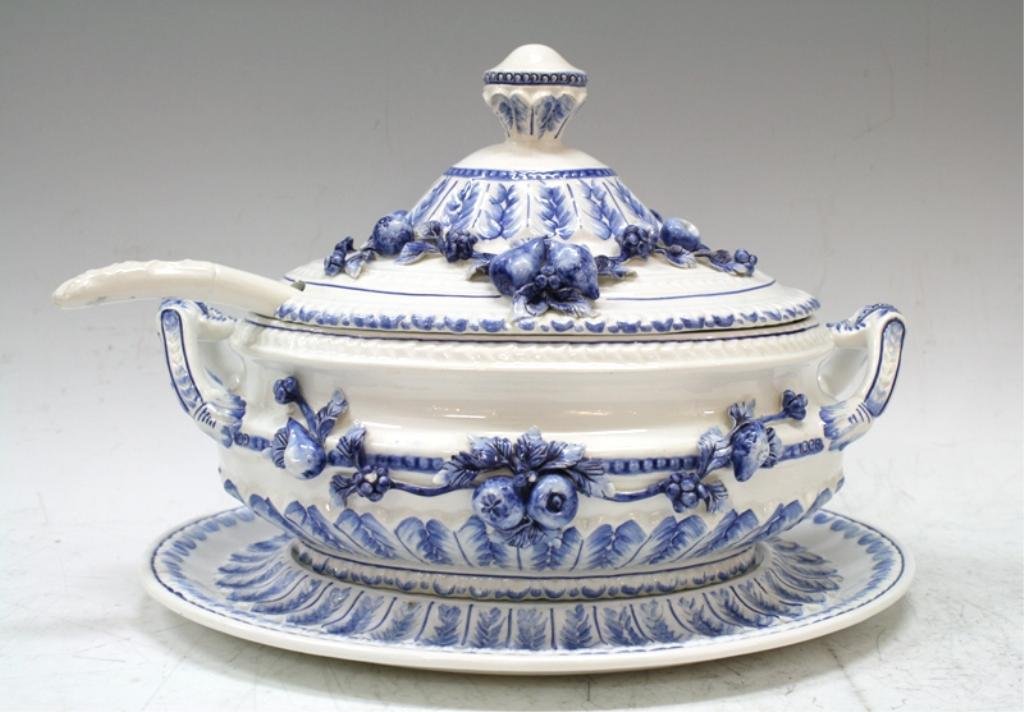 Capodimonte Style Covered Soup Tureen Set: A Capodimonte style porcelain soup tureen with lid, serving tray / platter, and spoon. Blue and white fruit relief design, Italy; marked. Dimensions: Tureen w/ lid 8-1/2" H x 12-1/2" L x 9-1/2" W; pla