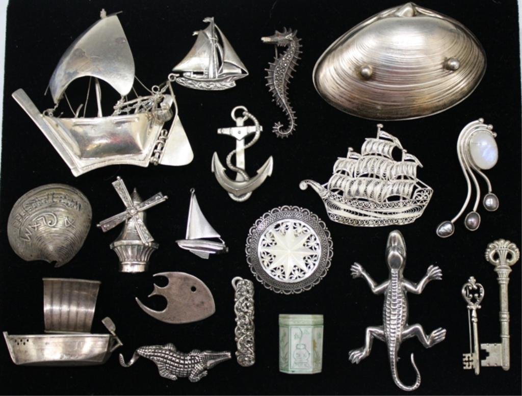 Lot of 19 Sterling Silver Nautical Themed Pieces: A lot of nineteen sterling silver nautical themed pins, one mother of pearl covered box, one moonstone and pearl brooch, and one small pocket knife with hook and blade. Weight and dimensions: 195 gram