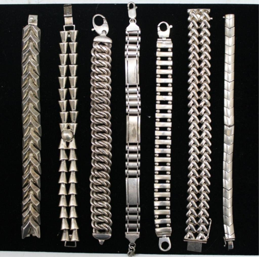 Lot of 7 Sterling Silver Chain Link Bracelets: Seven sterling silver bracelets including one Enrique Ledesma bracelet; several are marked "Italy". Weight and dimensions: 206 grams; 7" L - 8-1/2" L