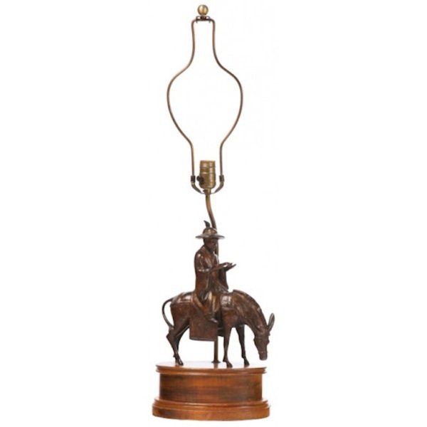 1950s Frederick Cooper Bronze Figural Lamp: Bronze horseback figure mounted as a table lamp by Frederick Cooper, c.1950s. The bronze figure has been mounted on an oval wooden base. Wired with brass fittings. Dimensions: 32" H x 10" L x 7" W