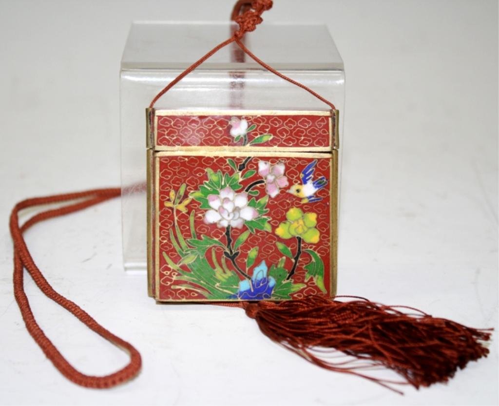 Chinese Red Cloisonne Box on String: A cloisonne box on string, China; unmarked. Dimensions: 2-1/2" H x 2-3/8" L x 7/8" W