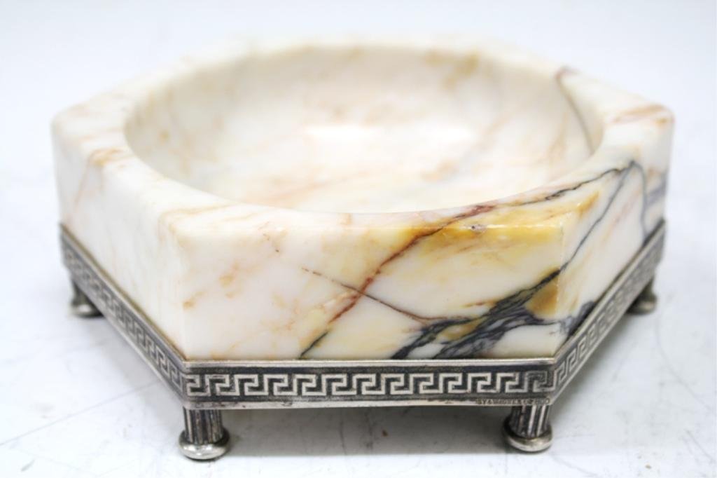 German Art Deco Carved Marble & Silver Bowl: A Sy and Wagner carved cream hexagonal marble bowl with black and amber veins on a 800 silver base with a band of Greek keys and fluted column feet, Germany, 1930; hallmarked by the Prussian court jew