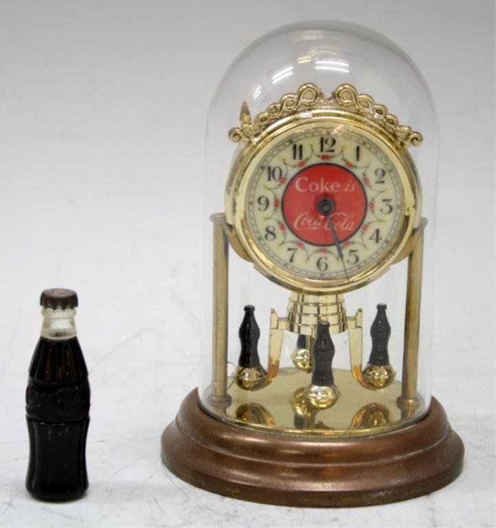 1934/36 World's Fair Coca Cola Clock & Lighter: A Coca Cola clock and bottle lighter, from the 1934 or 1936 World's Fair; marked. Dimensions: Clock 5-5/8" H x 3-3/4" diameter; Lighter 2-1/2" L x 3/4" diameter