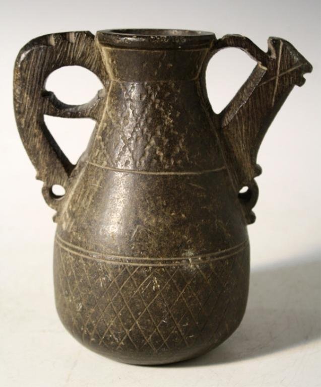 Islamic Stoneware Jug with Incised Decoration: Islamic jug with carved handle and spout, and incised decoration on body, stoneware; unmarked. Dimensions: approximately 7"H x 6" spout to handle x 4" diameter