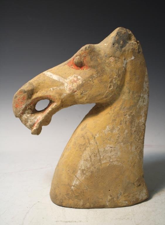 Chinese Pottery Horse Head poss. Han Dynasty: Head of horse with traces of pigment, pottery, China, possibly Han Dynasty (206 BC - 219 AD); unmarked. Provenance: Sotheby's Dimensions: approximately 10-1/2"H x 8"W x 3"D