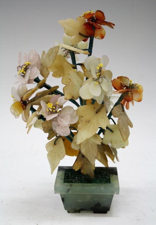 White Jade, Carnelian, Fluorite & Quartz Plant: A white jade, carnelian, rose quartz, and possibly aventurine stone plant sculpture in a fluorite planter. Wires are wrapped in string; unmarked. Dimensions: 10" H x 6" L x 5" W