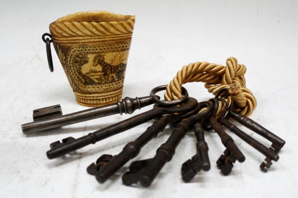 Lot of 2 Bone Drinking Cup & Antique Iron Keys: A bone drinking cup with wrought-iron ring handle engraved with a dog, goat and birds, Germany, circa seventeenth century. unmarked. Eight antique iron keys, England or America, eighteenth to nineteen