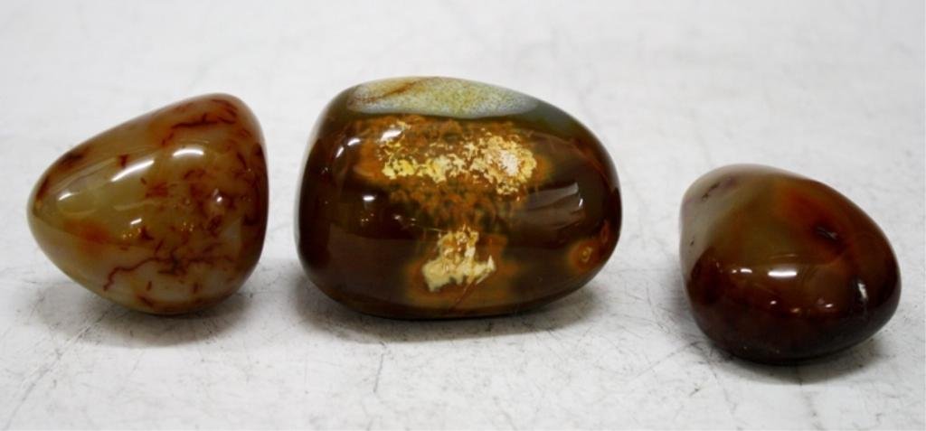 Lot of 3 African Madagascar Agate Stones: Three pieces of agate, Madagascar; unmarked. Dimensions: approximately 1) 2-1/4" H x 3-1/8" L x 2-1/4" W; 2) 1-3/8" H x 3" L x 2" W; 3) 1-7/8" H x 2-1/2" L x 2" W