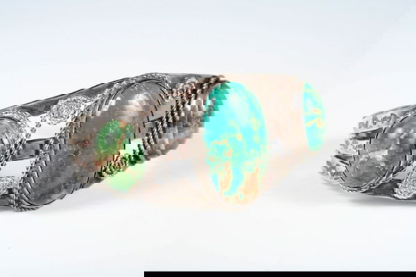 Ladies Navajo 3 Stone Turquoise Cuff Late 1920s: Handsome large green cast turquoise stones-measures 1 3/8" x 3/4" largest center stone. Etched detailing on the bracelet depicting arrows, thunderbirds, snakes and stars.