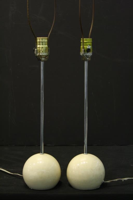 Pair Kovacs Ball Lamps: Having a composite-filled cream-color lacquered metal ball base and chrome stem, sticker label to base. 16" H (to socket).