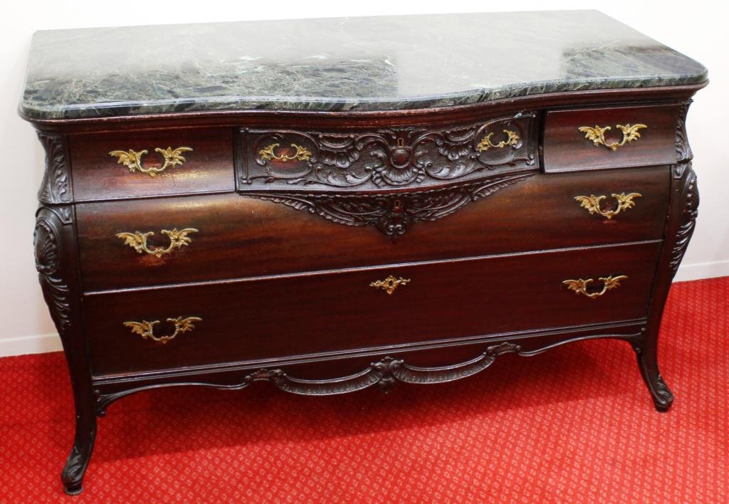 Ormolu-Mounted Marble-Topped Bowfront Buffet: The stained walnut case with a dark green and cream shaped marble top, below three short drawers over two long drawers, the center short drawer face fully carved with foliage and an escutcheon, a smal