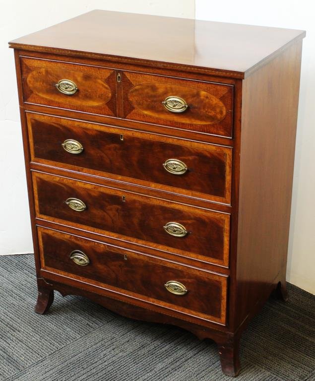 Antique Hepplewhite Chest of Drawers: Circa 1800-1810, mahogany- and satinwood-veneered, with four cockbeaded long drawers, the top drawer with inlaid ovals, plain and checkerboard banding used throughout, embossed acorn brasses, on high 