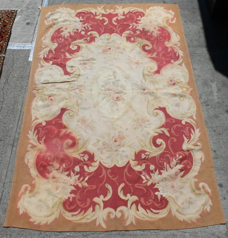 Aubusson Rug, 4' X 6' 2": Having a red ground, with cream and pink floral elements within a taupe border. Some running to dyes.