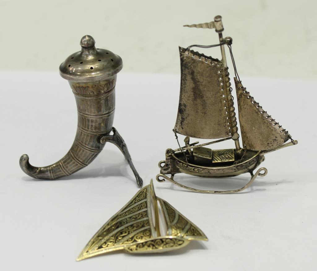 3 Scandinavian-Themed Metal Articles, incl. Silver: The first a novelty salt shaker in the form of a Viking drinking horn, marked "Sterling/ Sweden" on its supports; the second a miniature silver fishing-boat, complete with silver sails and pilot, with