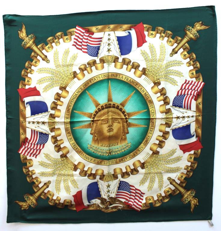 Hermès Vintage Green "Liberty Centennial" Scarf: Silk, the square scarf printed with the face of the Gustave Eiffel's colossal statue, a commemorative inscription of the work's centennial, and an array of Americana motifs and French flags, all surro