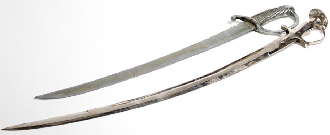 2 Silvered Metal Belly Dance Scimitars / Swords: The shorter stamped illegibly on the ricasso. Longest: 33" L. Both with wear and silver loss to blades. Property from the estate of the noted belly dancer Serena Wilson.
