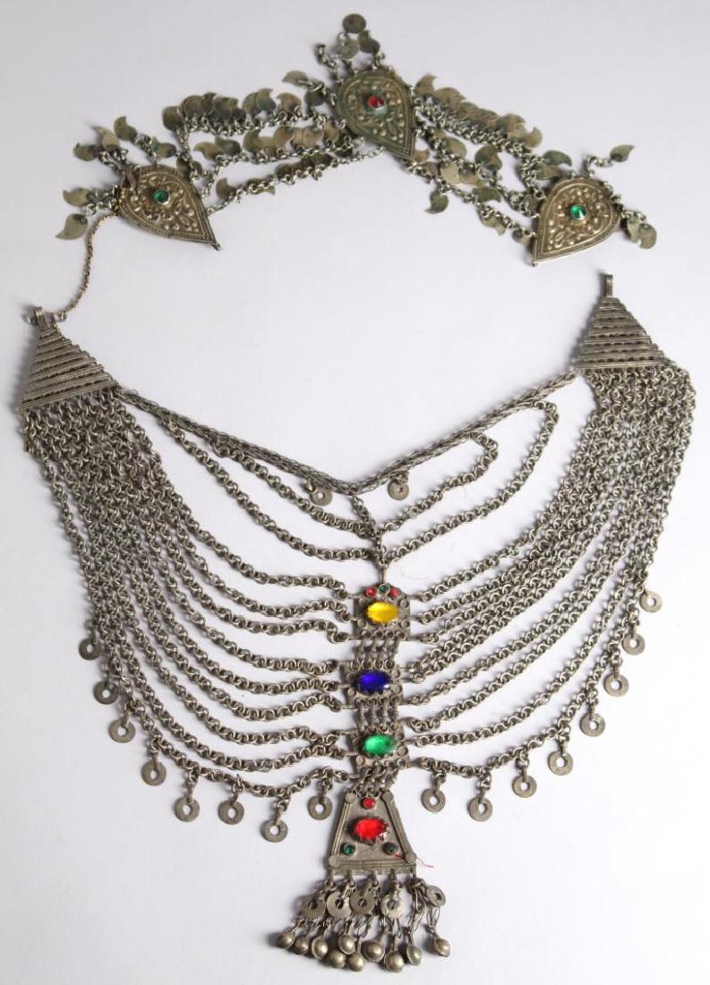 2 North African Tribal Chain Jewelry Articles: Both of silver-tone metal inset with faux jewels. Larger: 9.5" H X 14.5" L. Property from the estate of the renowned belly dancer Serena Wilson.