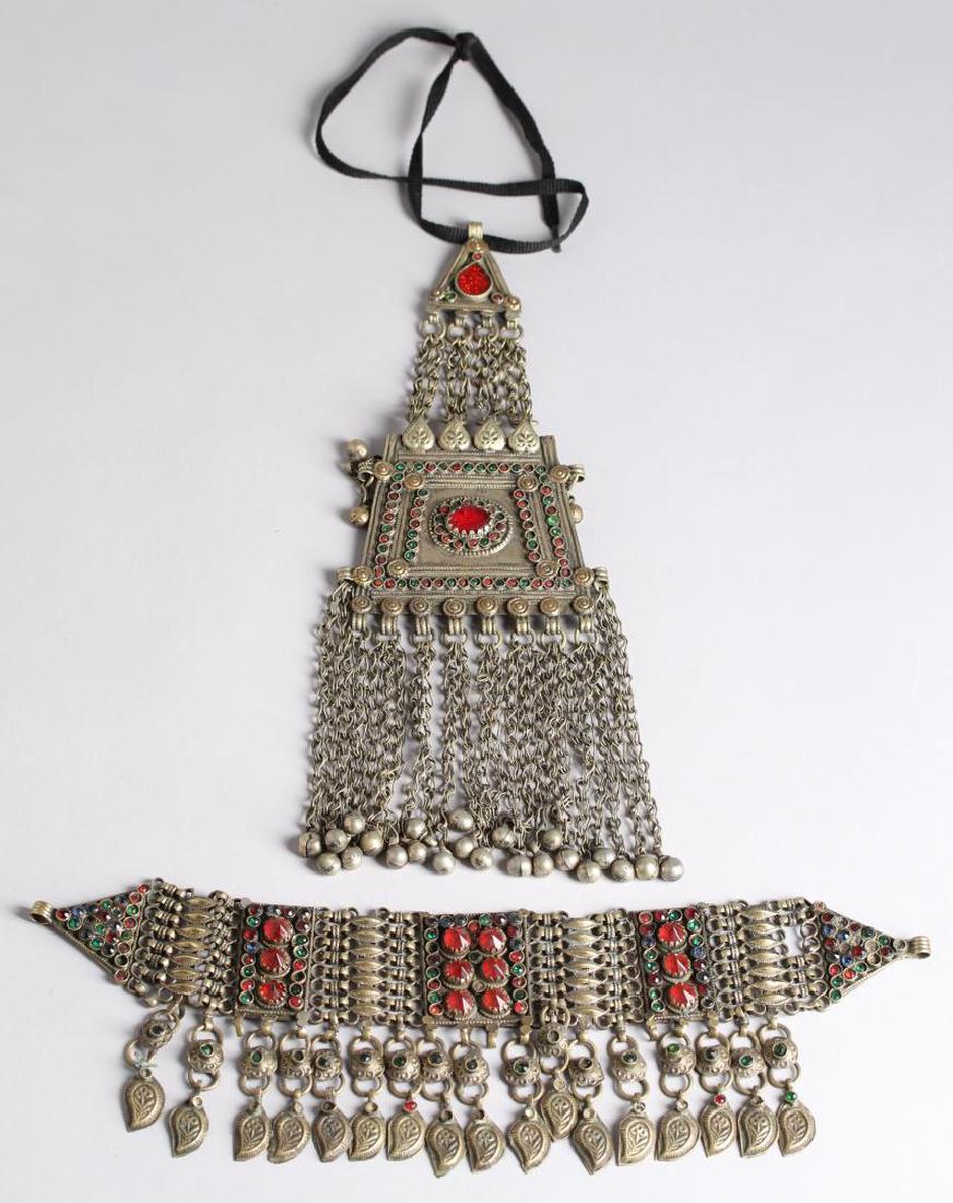 2 North African Tribal Chain Jewelry Articles: Two elaborate ornaments mounting faux jewels. Largest: 11.5" L. Lacking some stones. Property from the estate of the renowned belly dancer Serena Wilson.