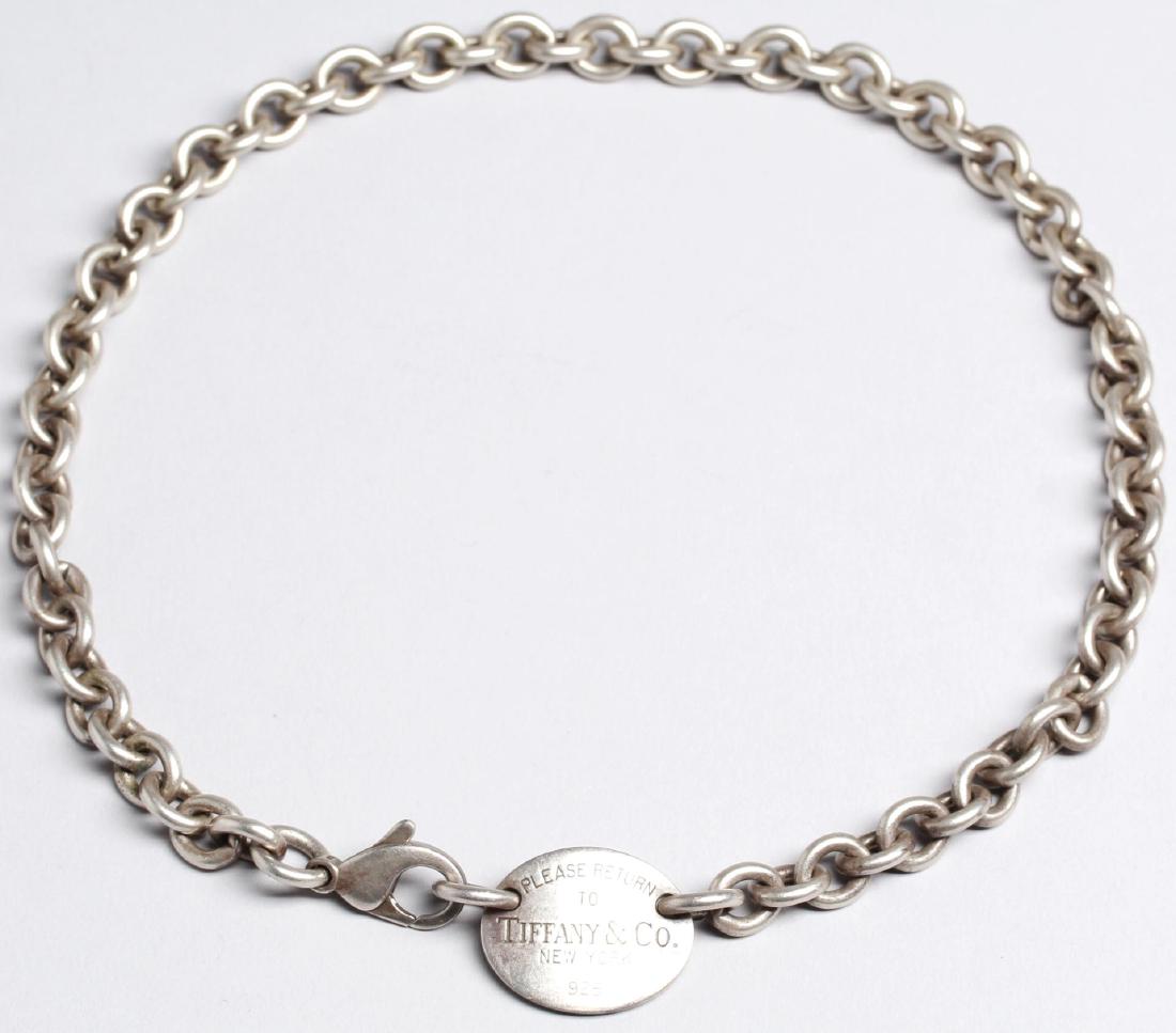 Vintage "Return to Tiffany"-Tag Silver Choker: The sterling disc attaching to a link chain, reading "Please Return to Tiffany & Co. / New York / 925." 15" L. Apx. 1.75 ozt.