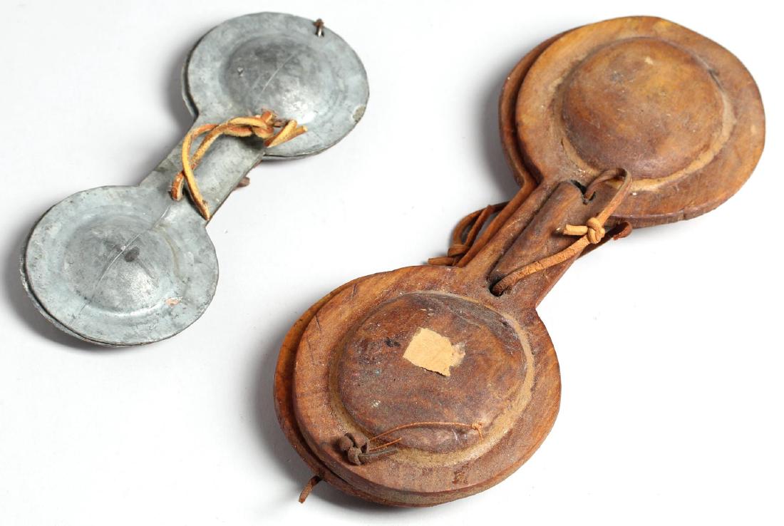 2 Moroccan Hand Clapper Instruments: The larger of wood, the smaller of white metal. Larger: 11" L closed. Minor wear to each. Property from the estate of the renowned belly dancer Serena Wilson.