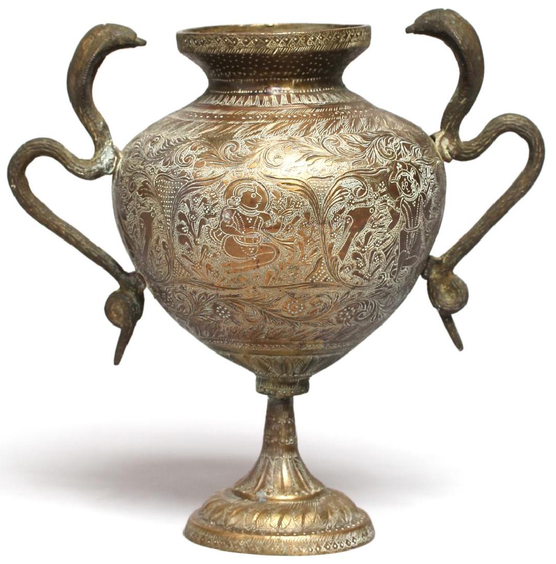 Indian Bronze Vase with Cobra Handles: The heavily incised globular form with widened everted lip having alternating border of the Hindu deities Hanuman and Lakshmi amid a layered arabesque of lions and birds flanked by two cobra form hand