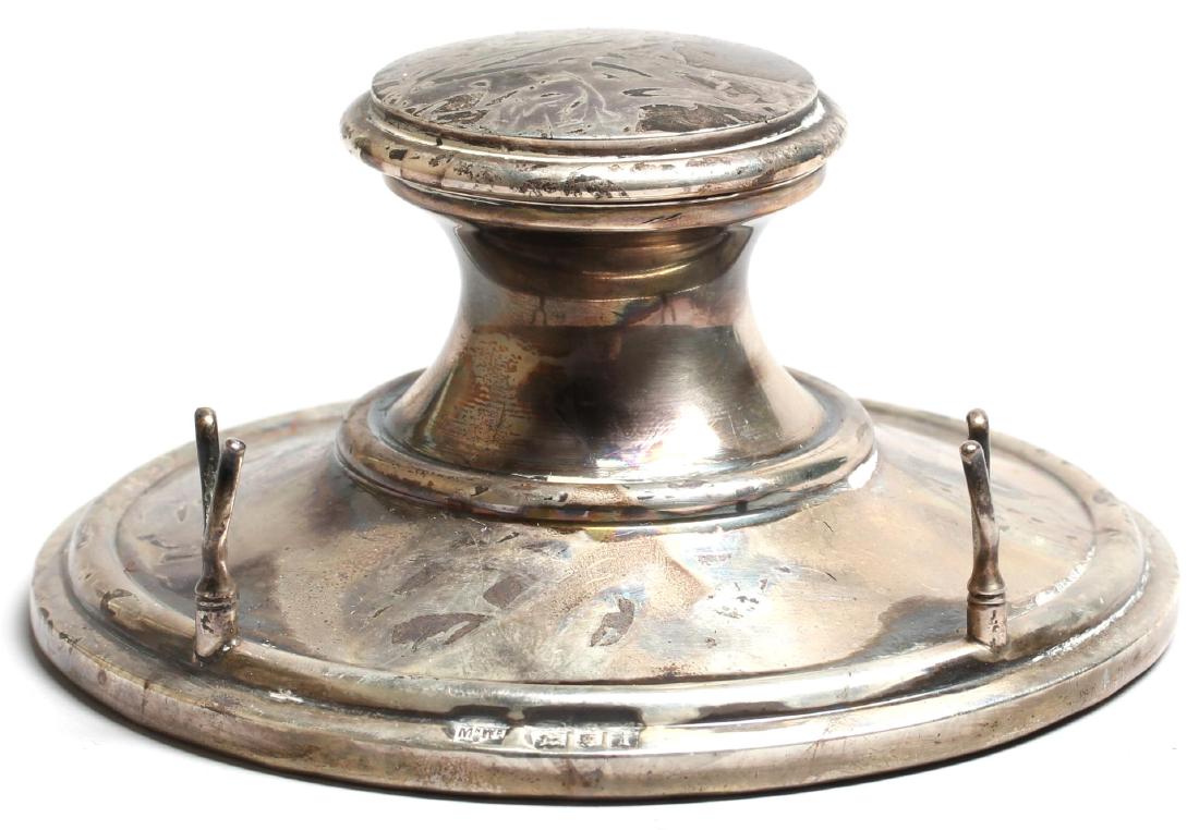 20th Century Weighted Silver Inkwell: Sterling silver inkwell with plastic ink insert, having two supports to lay pen, bearing London silver hallmarks, a 1924 "I" date mark, and the "MNWB" maker's hallmark of Mappin & Webb on foot and int