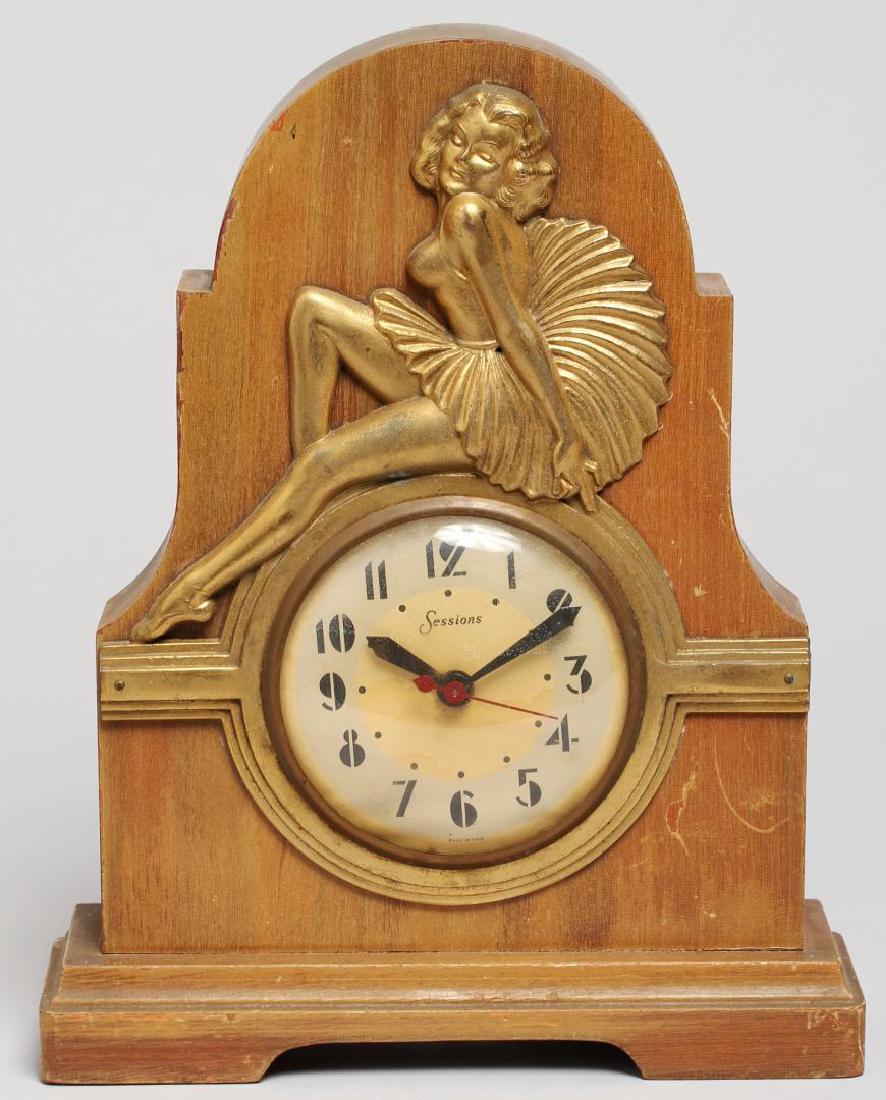 Sessions Art Deco Wood Electric Mantel Clock: With a gilt-painted beauty atop the paper clock face, having Arabic numerals and marked "Sessions." 11" H X 9" W X 3" D. Very minor surface scratching to case. Property from the estate of the renowned