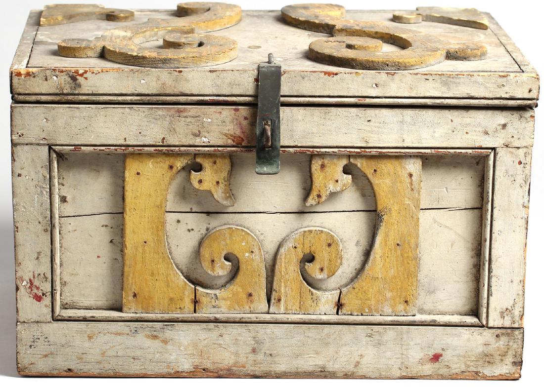 Milk-Painted & Iron-Mounted Wooden Chest: Hand-carved with four inset panels, the sides having attached yellow circular medallions, the front and top with stylized C- and S-scrolls.. 10" H x 15" W X 11" D.