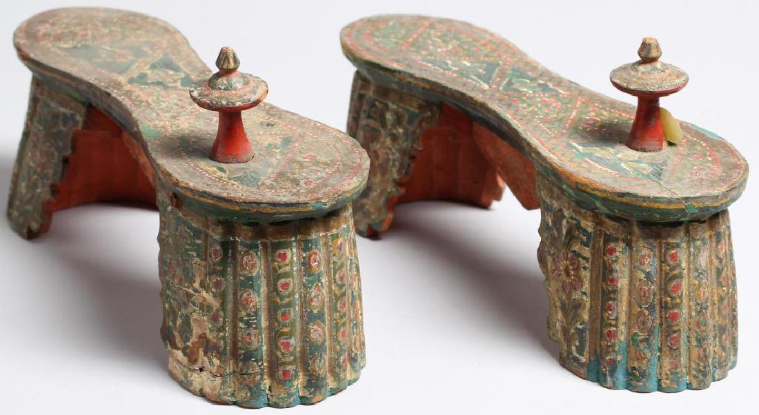 Pair of Elaborate Carved & Painted Pattens: With floral and geometric designs covering the scalloped bases. 6" H X 10" L. Property from the estate of the renowned belly dancer Serena Wilson.
